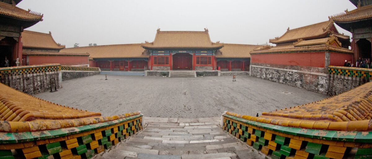 Tiananmen Square in Beijing with visitors and the Gate of Heavenly Peace under a blue sky