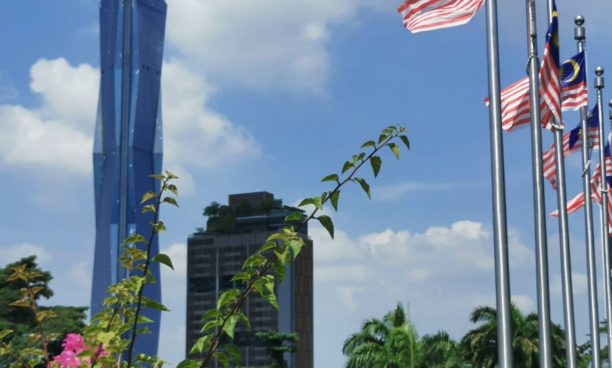 Tourists walking through Kuala Lumpur Chinatown near Central Market and colourful shopfronts