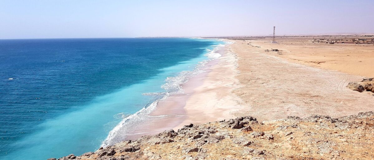 Traditional beachfront bungalows at Turtle Beach Resort facing a calm bay at sunset