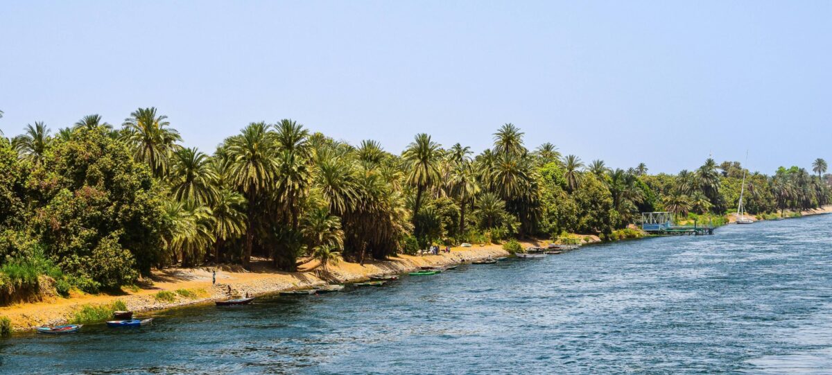 Traditional Dahabiya boat passing through Esna lock on the Nile with crew handling ropes