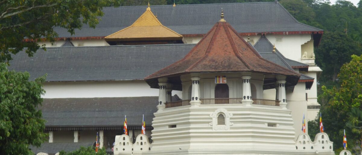 Traditional Kandyan dancers in colourful costumes performing with drums in a cultural show in Kandy, Sri Lanka