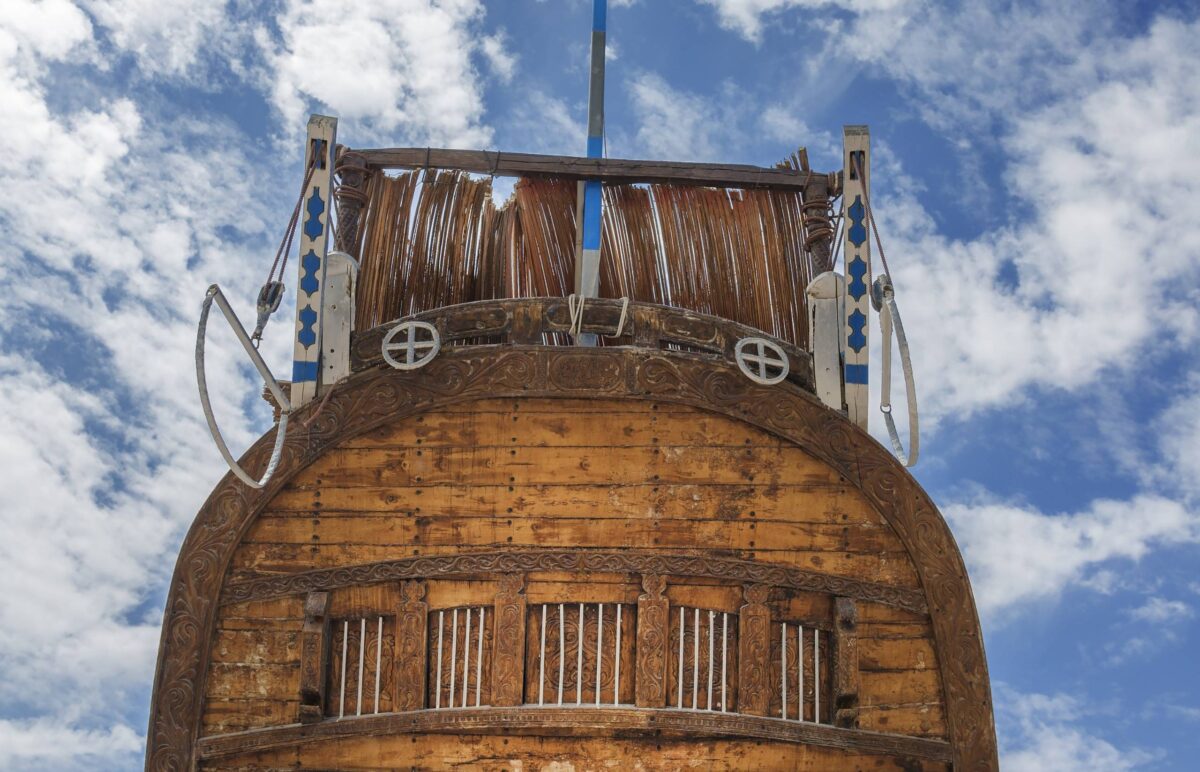 Traditional wooden dhow boats under construction in a shipyard in Sur, Oman