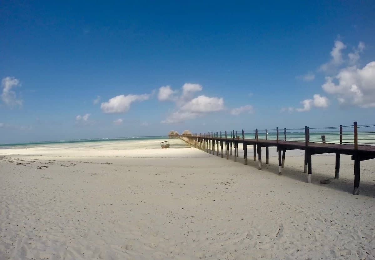 Traditional wooden dhow sailing on the turquoise waters of the Indian Ocean near Zanzibar
