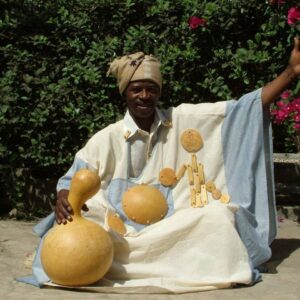 Traditional wooden pirogue gliding through the mangrove-lined waterways of Senegal’s Saloum Delta at sunset