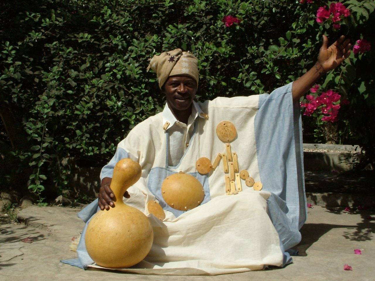Traditional wooden pirogue gliding through the mangrove-lined waterways of Senegal’s Saloum Delta at sunset
