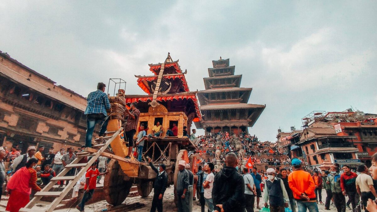 Traveler arriving at Kathmandu airport with view of traditional architecture and distant hills