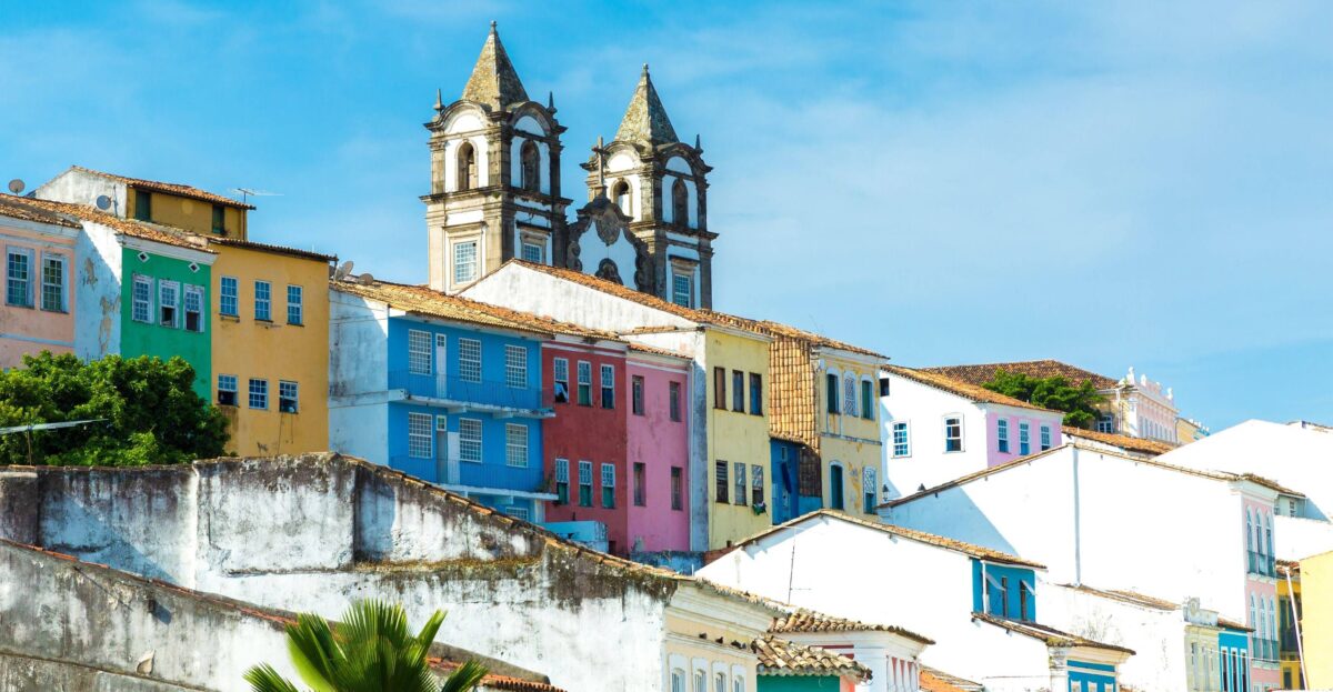 Traveler arriving in Salvador da Bahia airport with view toward the historic city and the sea in the background