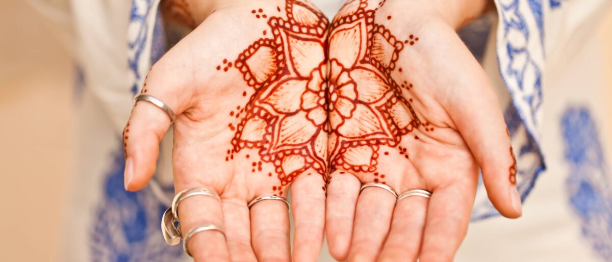 Traveler looking out over Muscat’s coastline from an airplane window during departure at sunrise