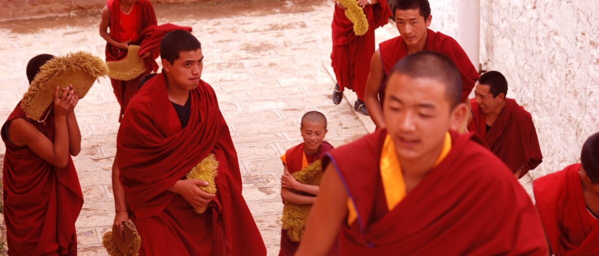 Traveler looking out over the mountains and town of Zhongdian (Shangri-La) before departure