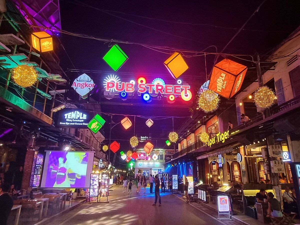 Traveler relaxing by a pool at a boutique hotel in Siem Reap surrounded by tropical greenery