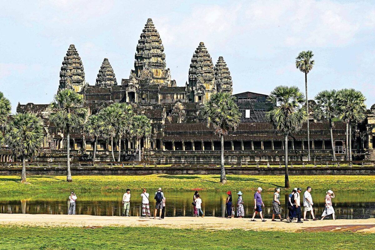 Traveler with luggage walking into the departure hall of Siem Reap airport