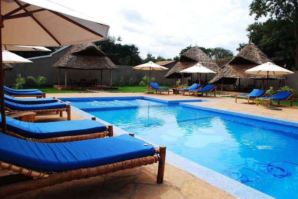 Traveler with luggage walking towards the entrance of Kilimanjaro International Airport