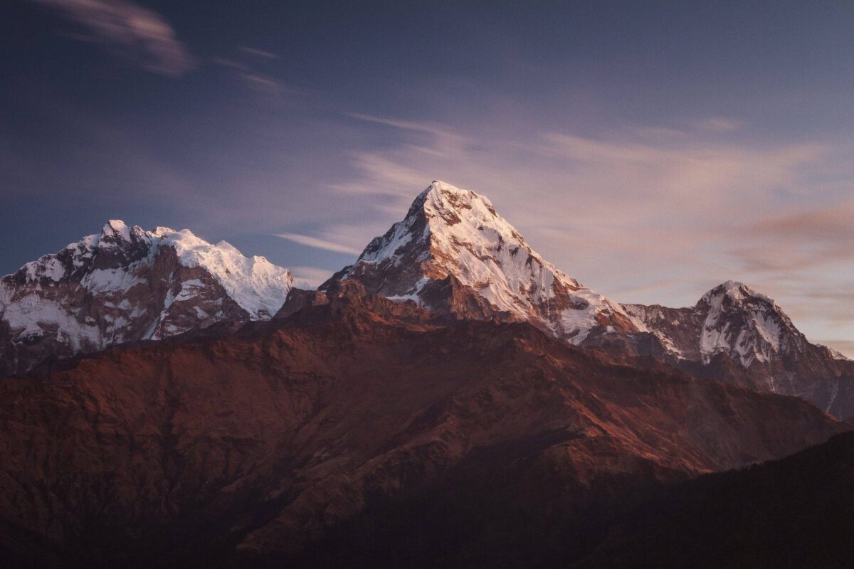 Travelers watching sunrise over Annapurna and Dhaulagiri from Poon Hill viewpoint