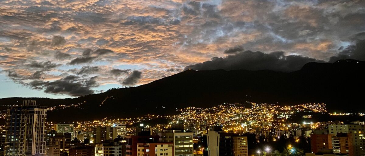 Travellers arriving at Quito airport with views of surrounding Andean hills in the background