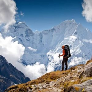 Trekking group walking along a mountain trail towards the snow-covered peaks of the Annapurna range under a clear blue sky in Nepal