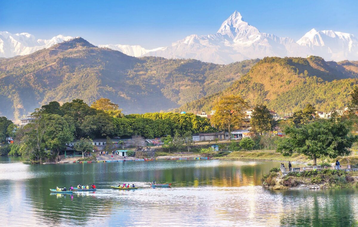 Trekking path near Nayapul following a river with terraced fields and scattered houses in the hills