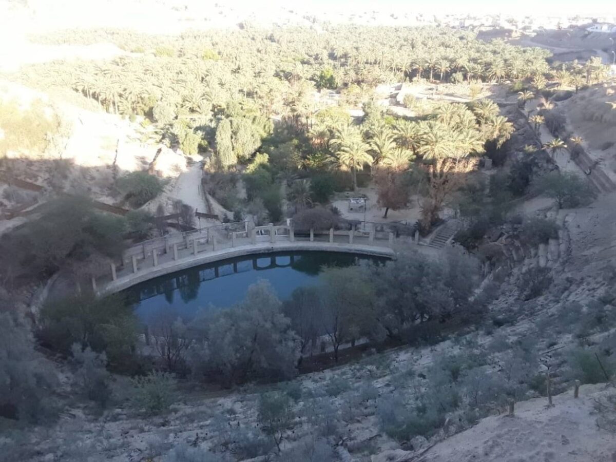 Troglodyte houses carved into the rock in Matmata, Tunisia, with desert hills and blue sky in the background