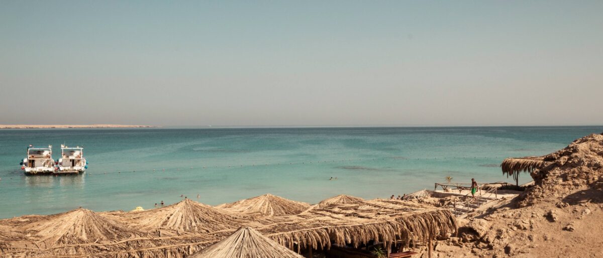 Turquoise Red Sea waters and a boat near Hurghada with people snorkeling