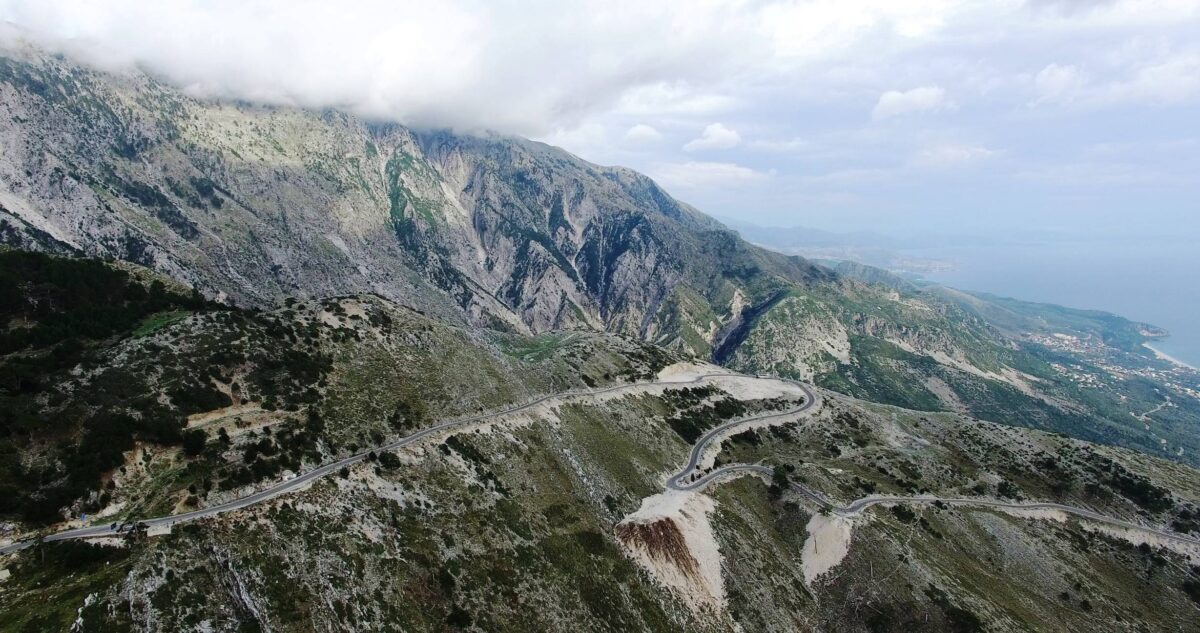 View from Llogara National Park over forested mountains descending to the turquoise Albanian Riviera