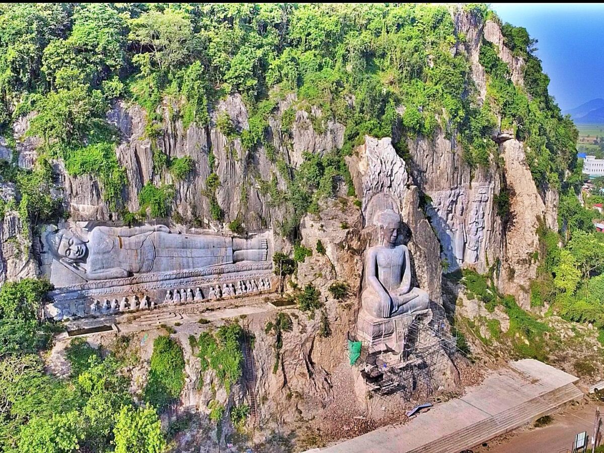 View from Phnom Sampov hill over green rice fields near Battambang at sunset with a pagoda on the ridge