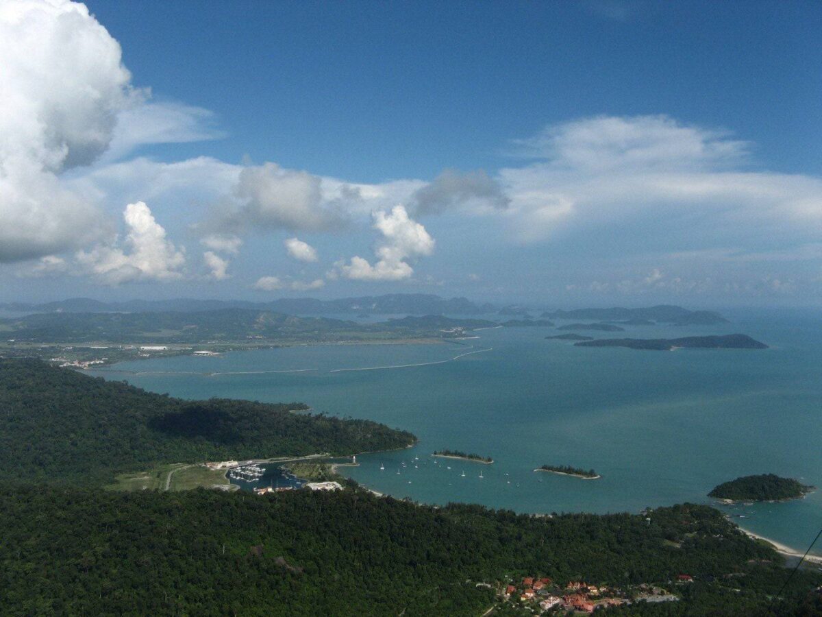 View of Langkawi coastline from above with tropical greenery, beaches and the sea at sunrise