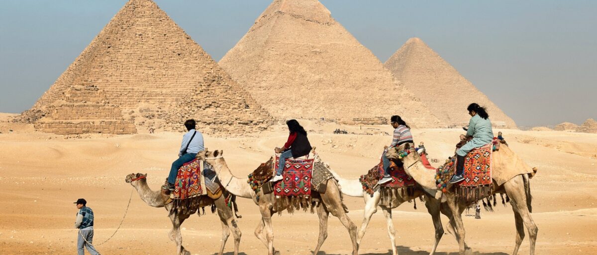 View of the Great Pyramid of Giza and the Sphinx under a sunny sky near Cairo