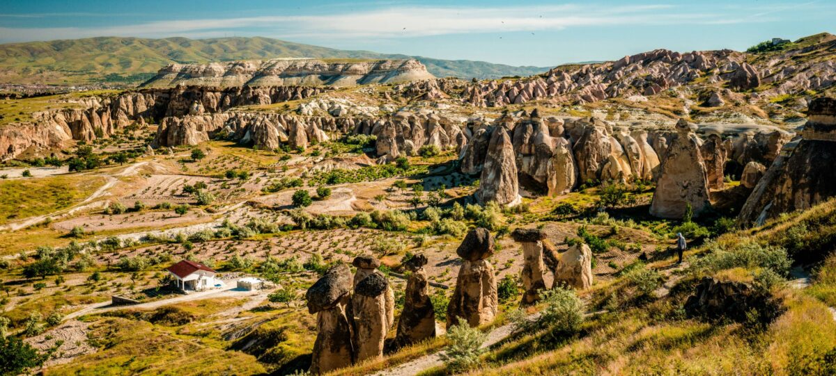 View over Cappadocia’s Red Valley at sunset with rugged cliffs and walking paths