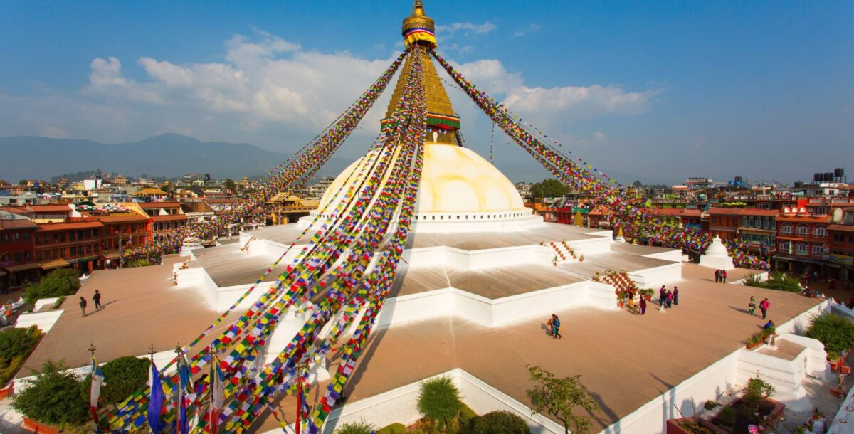 View over Kathmandu city with traditional houses and distant Himalayan foothills under a hazy sky