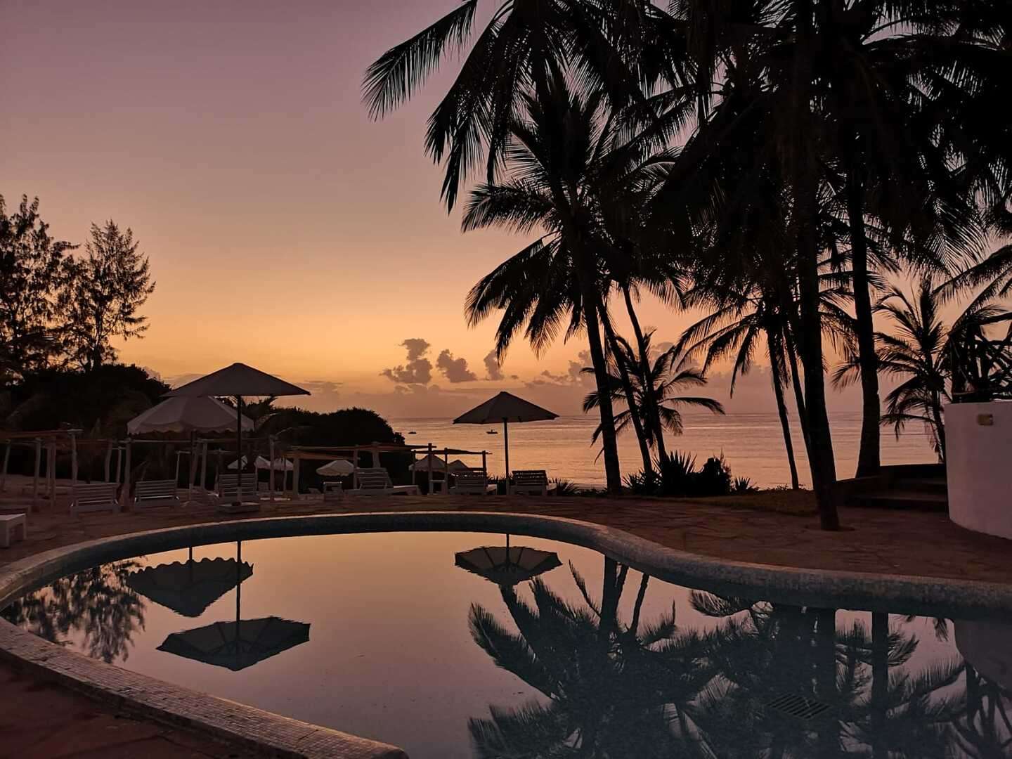 View over Kenya’s Tsavo East savannah with grazing wildlife under a wide blue sky