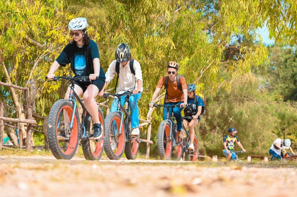 View over Lake Retba in Senegal with people relaxing near an infinity pool at sunset