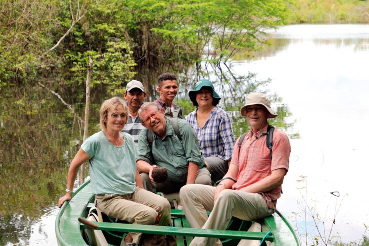 View over Manaus and the Rio Negro at sunrise with planes on the runway of Manaus airport in the distance