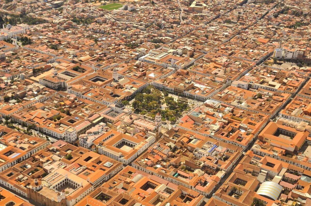 View over Sucre’s white colonial buildings and red-tiled roofs beneath a bright blue Andean sky