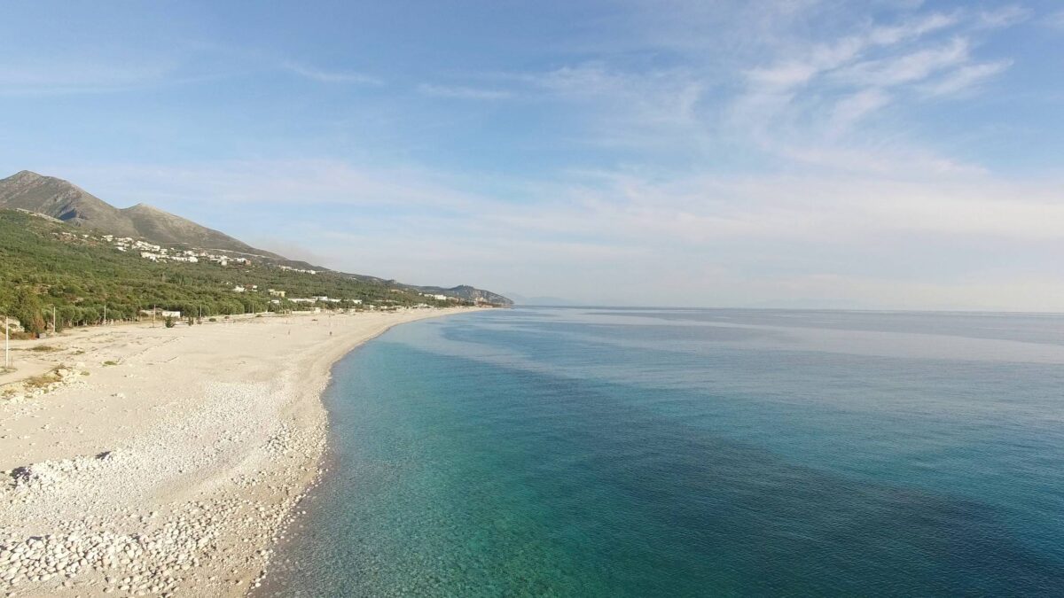 View over the Albanian Riviera with terraced hills, olive groves and the blue Ionian Sea near Borsh