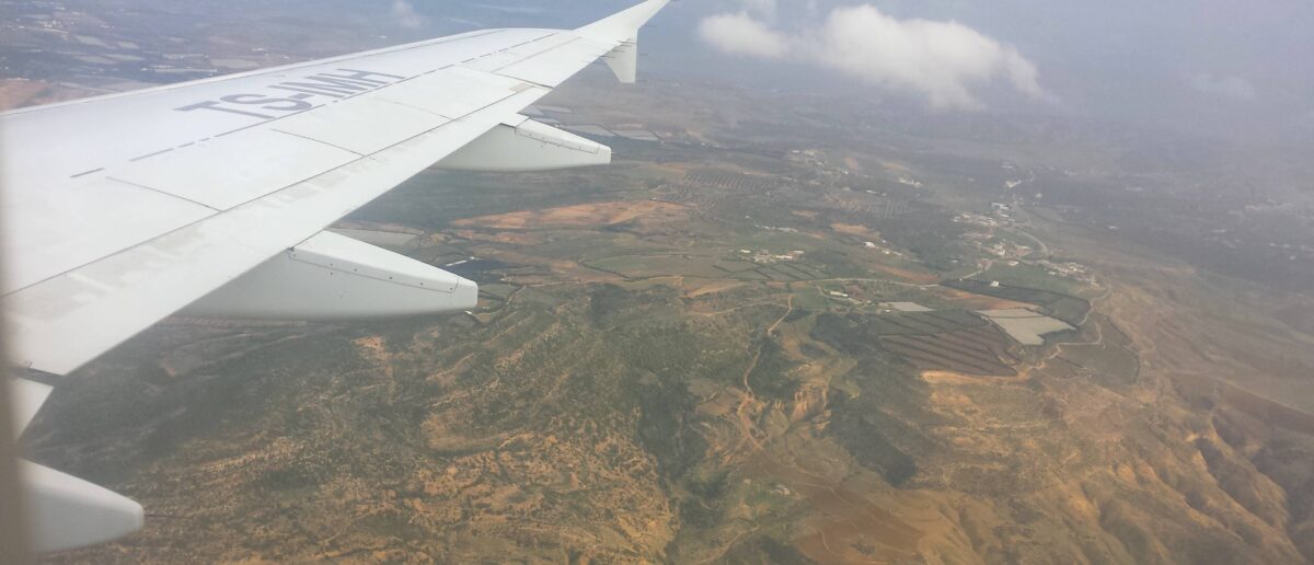 View over Tunis with city rooftops and distant hills under a clear blue sky