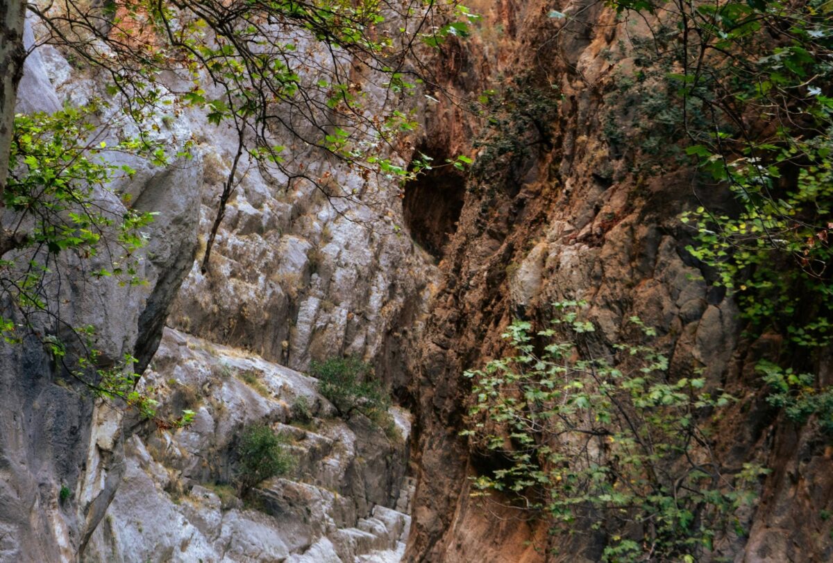Visitors walking on wooden platforms along the sheer rock walls of Saklikent Canyon in Turkey