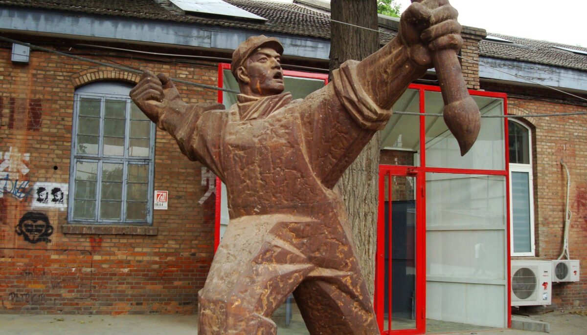 Visitors walking through Beijing’s 798 Art District with industrial buildings converted into galleries