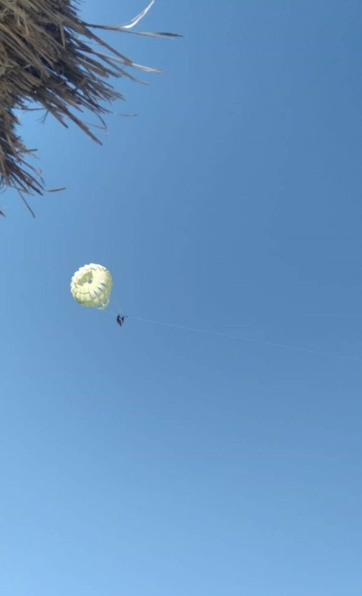 Wide sandy beach with turquoise water and sun loungers on the island of Djerba, Tunisia